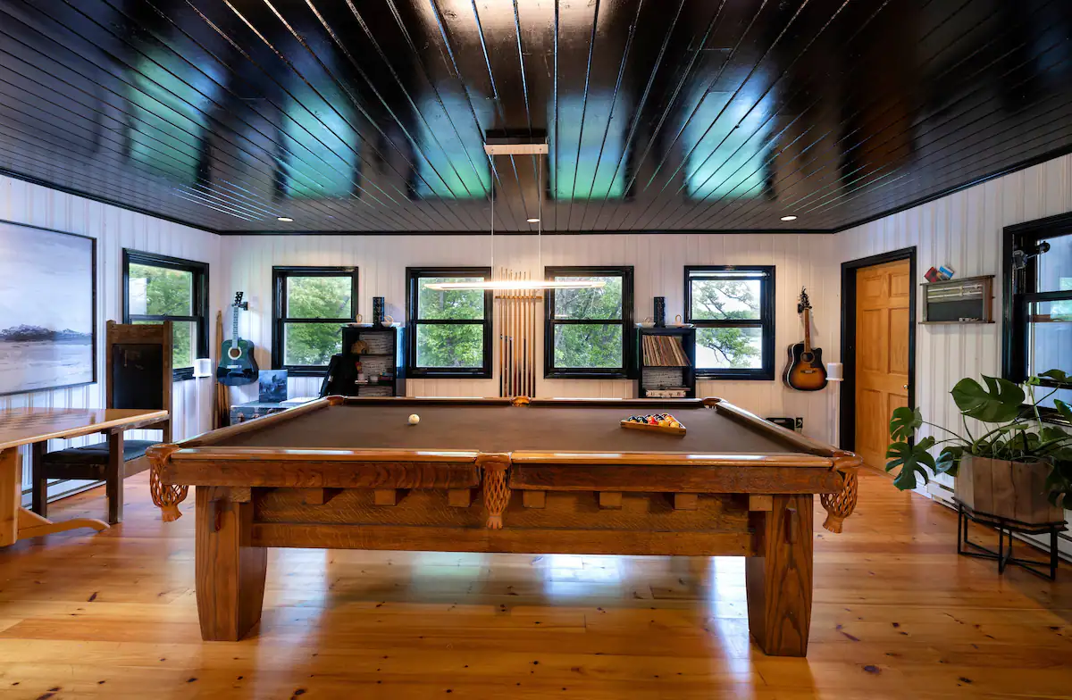 The bar and games room comes complete with a pool table, bar and ice maker, guitars, and pool table!